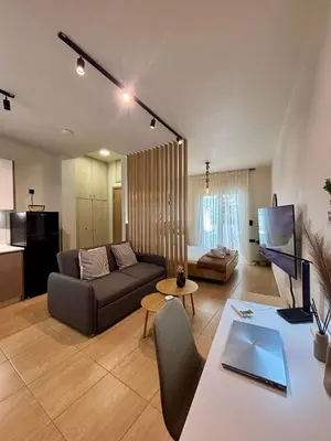 a living room with a couch and a table at Thymeli Cozy Apartment in Athens