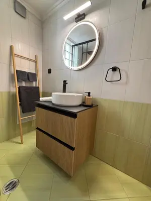 a bathroom with a sink and a mirror at Thymeli Cozy Apartment in Athens
