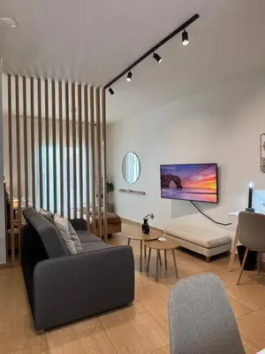 a living room with a couch and a table at Thymeli Cozy Apartment in Athens