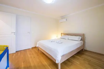 a bedroom with a large white bed with white pillows at Elegant Urban Retreat in Psychiko in Athens
