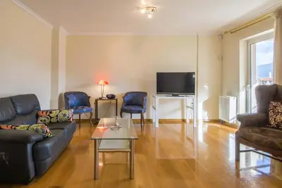 a living room with a couch and chairs and a tv at Elegant Urban Retreat in Psychiko in Athens