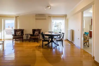 a living room with a dining room table and chairs at Elegant Urban Retreat in Psychiko in Athens