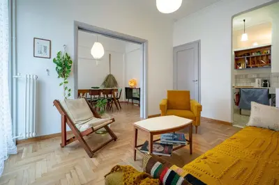 a living room with a couch and a table at Artistic Bright Apartment - Attiki Metro by ΜΡS in Athens