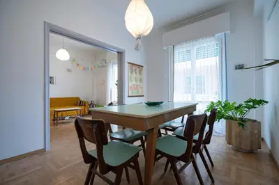 a dining room with a table and four chairs at Artistic Bright Apartment - Attiki Metro by ΜΡS in Athens