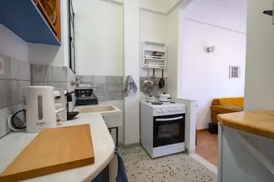 a small kitchen with a stove and a sink at Artistic Bright Apartment - Attiki Metro by ΜΡS in Athens