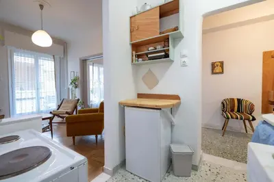 a kitchen and living room with a counter in a room at Artistic Bright Apartment - Attiki Metro by ΜΡS in Athens