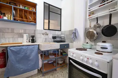 a kitchen with a stove and a counter top at Artistic Bright Apartment - Attiki Metro by ΜΡS in Athens