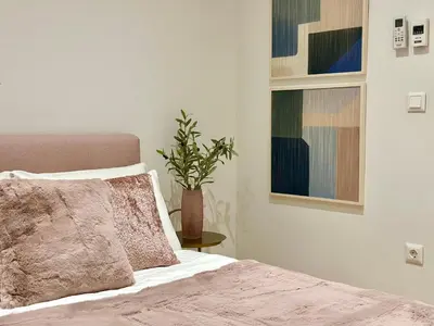 a bedroom with a bed and a potted plant at Elaia Luxury Selections - Aqua Marine in Athens
