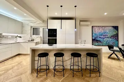 a kitchen with a large island with bar stools at Elaia Luxury Selections - Aqua Marine in Athens