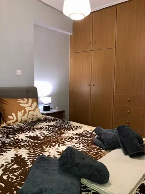 a bedroom with a bed with a dresser and a bed sidx sidx at Goudi Athenian 4th floor Apartment in Athens