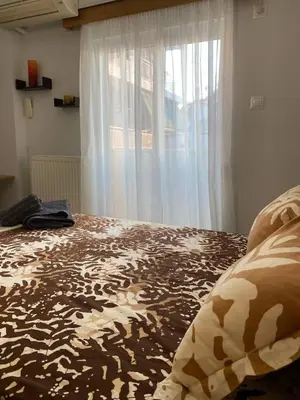 a bedroom with a large bed with a window at Goudi Athenian 4th floor Apartment in Athens