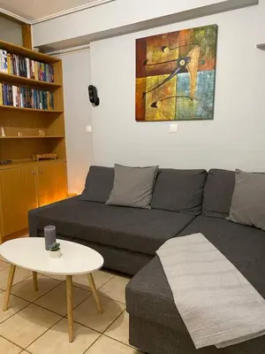 a living room with a couch and a table at Goudi Athenian 4th floor Apartment in Athens