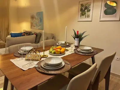 a dining room table with fruits and plates on it at Alimos Skyline Balcony Home in Athens