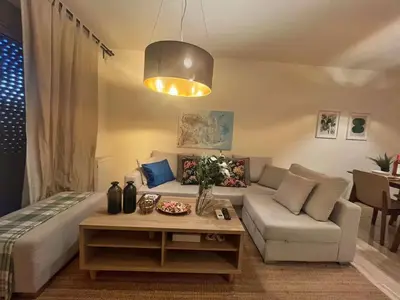 a living room with a couch and a table at Alimos Skyline Balcony Home in Athens