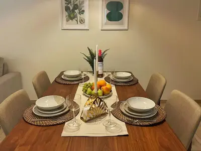 a dining room table with a bowl of fruit on it at Alimos Skyline Balcony Home in Athens