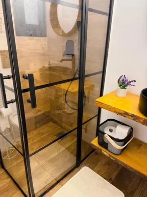 a shower with a glass door in a bathroom at The Cozy Spot Athens in Athens