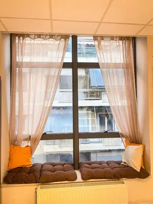 a large window with a couch in front of it at Sharing Apartment in Athens