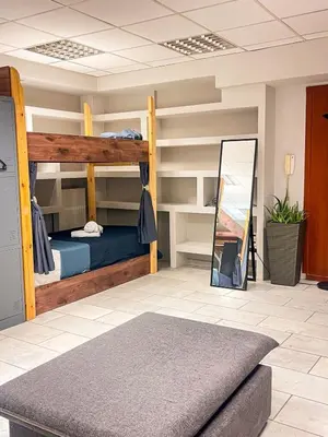 a room with bunk beds and a mirror at Sharing Apartment in Athens