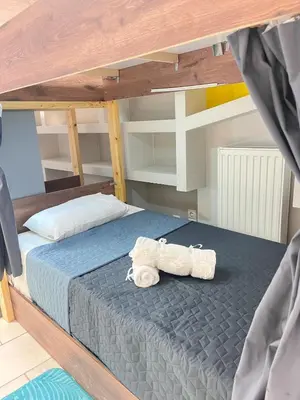 a bunk bed with a stuffed animal on it at Sharing Apartment in Athens