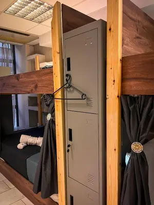 a bunk bed with a door in a room at Sharing Apartment in Athens