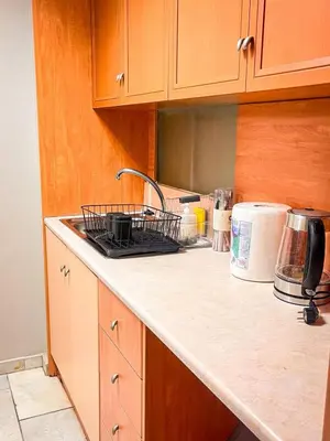 a kitchen counter with a dish rack on the counter top at Sharing Apartment in Athens