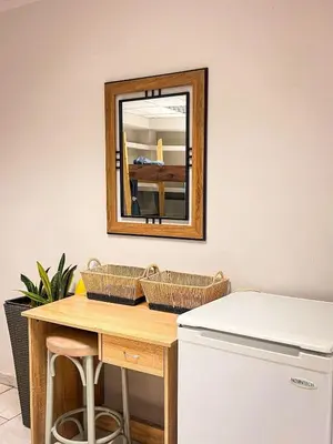 a mirror on a wall next to a table at Sharing Apartment in Athens