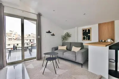 a living room with a couch and a table at EL Attico, Αθήνα in Athens