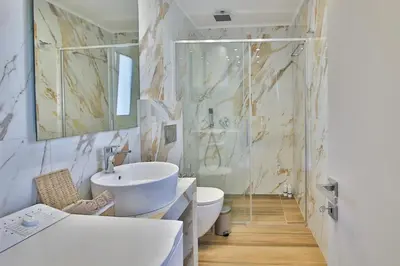 a bathroom with a sink and a toilet and a shower at EL Attico, Αθήνα in Athens