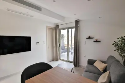a living room with a couch and a table at EL Attico, Αθήνα in Athens