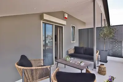 a living room with a couch and chairs and a table at EL Attico, Αθήνα in Athens