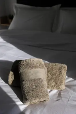 a towel is sitting on top of a bed at EL Attico, Αθήνα in Athens