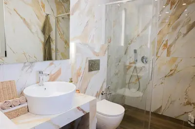 a bathroom with a sink and a toilet and a shower at EL Attico, Αθήνα in Athens