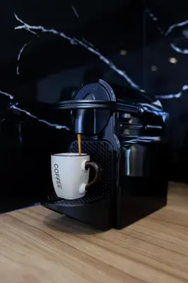 a coffee maker with a cup on a counter at EL Attico, Αθήνα in Athens