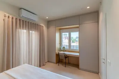 a bedroom with a bed and a window and a desk at MelAngelo Villas M - Modern Studio near Port of Piraeus in Piraeus