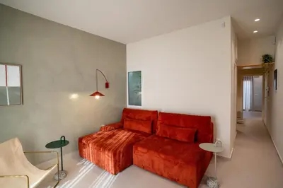 a bedroom with a red bed in a room at MelAngelo Villas M - Modern Studio near Port of Piraeus in Piraeus