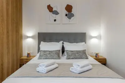 a bedroom with a bed with towels on it at Artemis Moonlight Suit in Athens