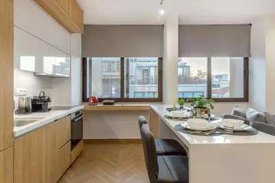 a kitchen with a large island with a table at Artemis Moonlight Suit in Athens