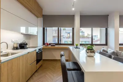 a kitchen with a large white counter and some windows at Artemis Moonlight Suit in Athens