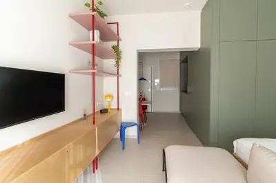 a living room with a tv and a couch at MelAngelo Villas A - Modern Studio near Port of Piraeus in Piraeus