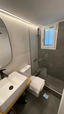 a bathroom with a toilet and a sink and a shower at 180 jacuzzi with Acropolis sunset view in Athens