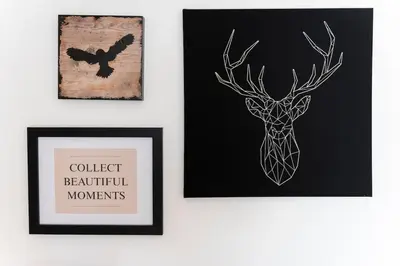 a wall with two framed pictures and a deer and a butterfly at 180 jacuzzi with Acropolis sunset view in Athens