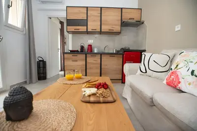 a living room with a table with food on it at Hot tub with Acropolis view 1 minute from METRO TRAIN in Athens