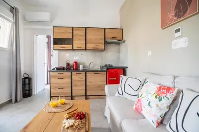 a living room with a couch and a table at Hot tub with Acropolis view 1 minute from METRO TRAIN in Athens