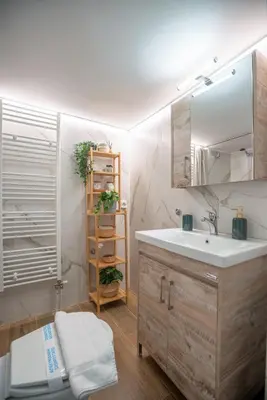 a bathroom with a sink and a mirror at Hot tub with Acropolis view 1 minute from METRO TRAIN in Athens