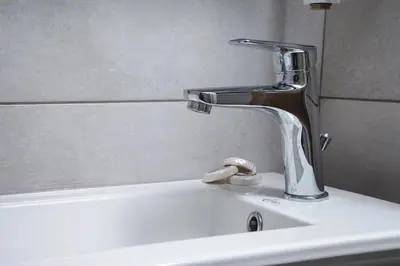 a sink with a faucet on top of it at Evelyn's cozy house in Athens