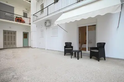 two chairs and a table in a white building at Evelyn's cozy house in Athens