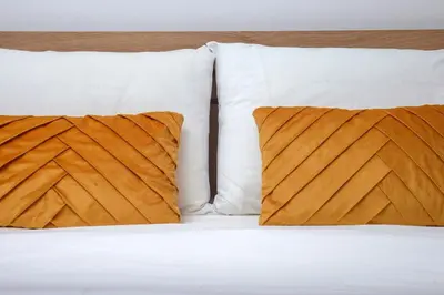 two pillows sitting on top of a bed at Evelyn's cozy house in Athens
