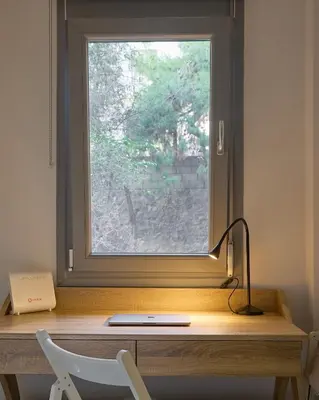 a desk with a window and a lamp on it at Modern & Cozy Studio in Kypseli in Athens