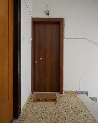 a wooden door in a room with a floor at Modern & Cozy Studio in Kypseli in Athens