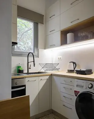 a kitchen with white cabinets and a sink at Modern & Cozy Studio in Kypseli in Athens